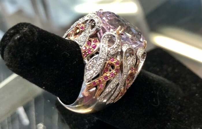 Kunzite ribbon ring with diamonds and rubies
