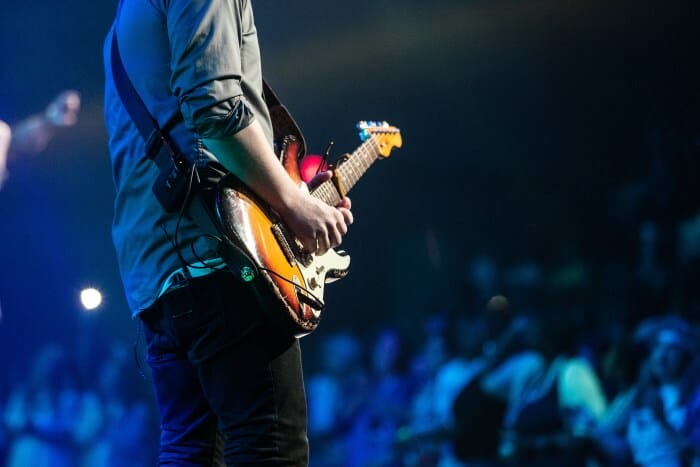 Musician playing guitar on stage