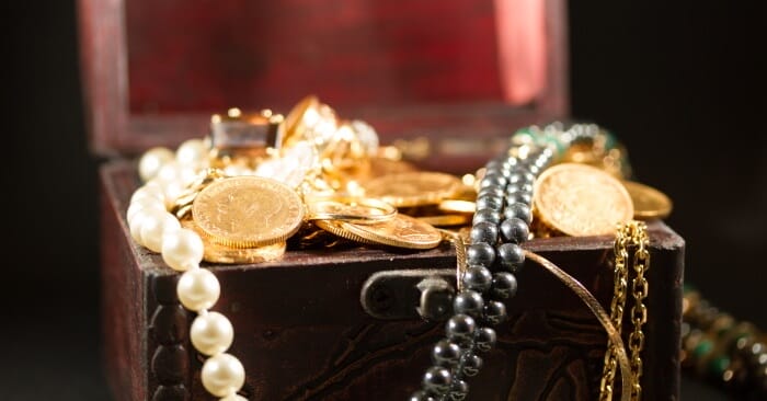 Gold and jewels spilling out of jewelry box
