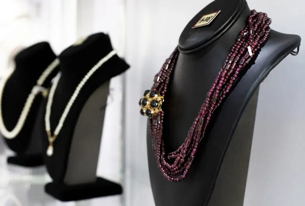 A beautiful necklace on display among other necklaces