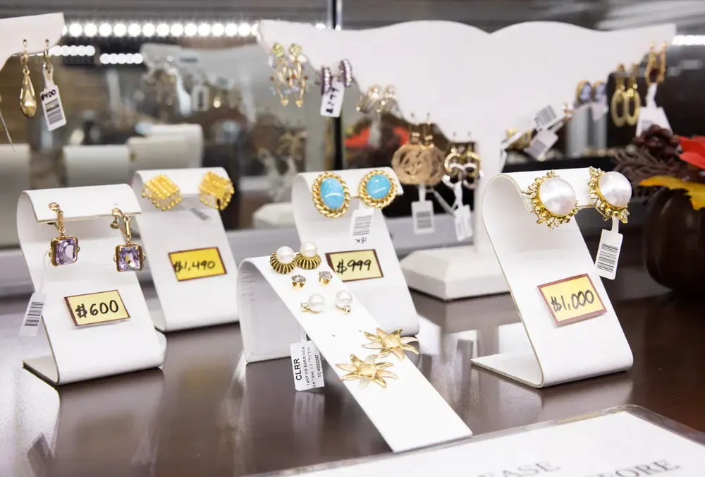Beautiful earrings displayed on a counter with price tags