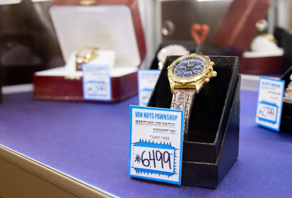 A luxury watch displayed with a price tag inside Maxferd's Van Nuys branch