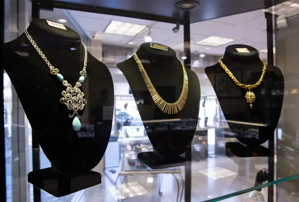 Elegant necklaces showcased inside a glass display case