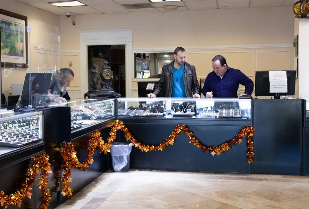 Staff members working behind the counters inside Maxferd's pawn shop